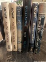Spines of all six Farley Mowat hardcovers showing titles and publishers