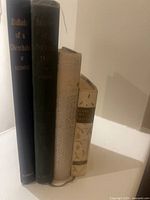 Spines of the four poetry books standing together