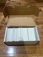 Opened card storage box showing stack of hockey cards