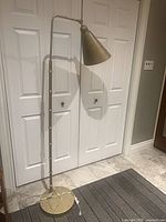 Full view of floor lamp showing height, stem, base and shade