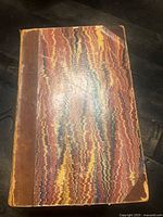 Front cover showing marbled boards and leather spine/corners