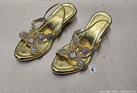 Top view of pair of gold rhinestone sandals