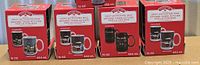 Four boxed Holiday Time heat-activated mugs front view
