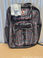 Front view showing plaid pattern, pockets, logo