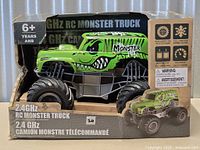 Front of boxed green RC monster truck