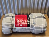 Rolled plaid twin comforter in packaging