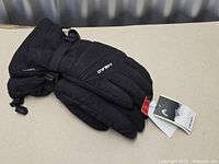 Full view of pair of black HEAD insulated gloves with tags attached