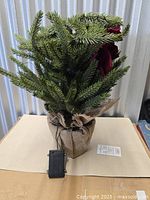 Full view of artificial porch tree with battery pack and burlap base