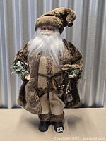 Full view of Santa figurine standing upright showing attire and accessories