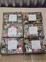 Six boxed sets of Gluckstein Home ornaments stacked