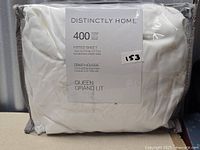 Packaged white fitted sheet showing brand and packaging