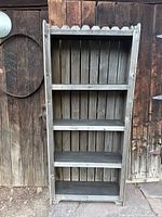 Front view of barnwood pine shelf unit showing four shelves, slatted back, scalloped top