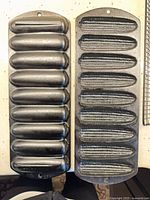Two black cast iron Lodge cornstick pans side by side