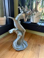 Front view showing full mermaid figure and wave base
