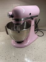 Pink KitchenAid Artisan stand mixer with bowl attached