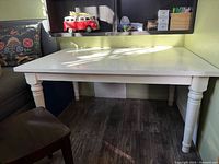 Front view of white table/desk under shelving