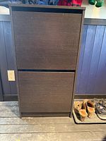 Front view of dark brown shoe rack closed