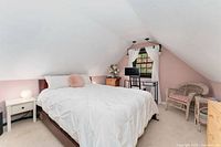 Bed featuring white comforter and pillows