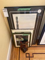 Overview of three framed prints and wooden mask