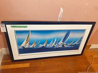 Full view of framed sailing print on floor