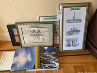 Group shot showing all framed art pieces and stack of Canadian photography books