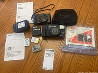 Overview of both cameras, charger, batteries, manuals, carry case