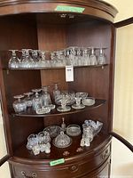 Full cabinet view showing multiple shelves of glassware