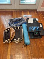 Overview showing Cubii elliptical, floor mat, yoga mat bag, collapsible tote and two storage bins