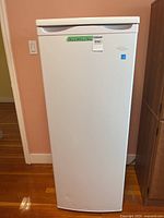 Front view of white Danby upright freezer