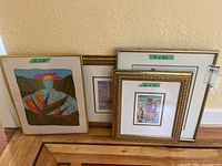 Group shot of all four framed artworks showing relative sizes and frame styles
