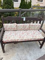 front view of wooden bench with paisley cushions