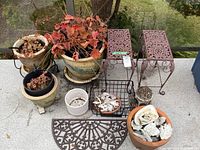 Group shot of all planters, stands, shells, basket and mat