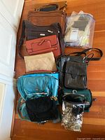 Group shot of all handbags, small bags and bag containing gloves