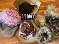 Group shot of all hats and wigs on floor