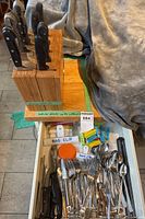Top view showing two knife blocks with knives, open drawer of cutlery and bag clips