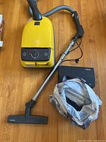 Full view of vacuum body, hose, wand, floor tool, bag pack