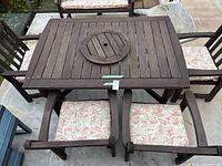 Top view of wooden patio table with chairs and cushions