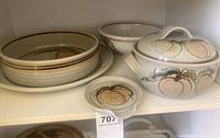 All five ceramic pieces on shelf showing relative sizes