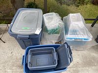 Overall lot showing multiple plastic totes and bins