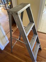 Side view showing A-frame structure and three steps