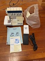 Sewing machine with dust cover, pedal, cord, manuals