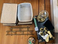 overview showing woven bins, clock, cymbals, tin, hooks, trunk