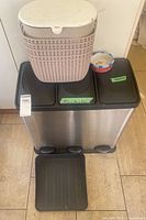 Overall view showing 3-compartment stainless bin, woven bin on top, pet bowl, plastic tray