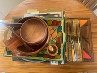 Overall lot showing wooden bowls, painted tray, carving set and trivet