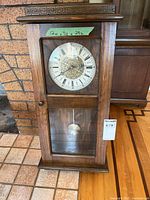 Full view of wooden pendulum wall clock