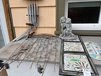 Group shot showing wind chime, metal wall panel, cherub statue and thermometer