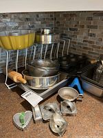 Group of assorted baking tins, bowls, molds, rolling pin