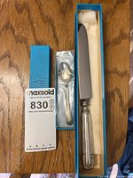 Teaspoon in sleeve and knife in Birks box