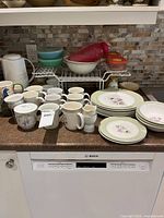 Overview showing dinner plates, bowls, mugs, teapot, rack, containers