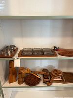 Shelf view of all wood and metal items in lot